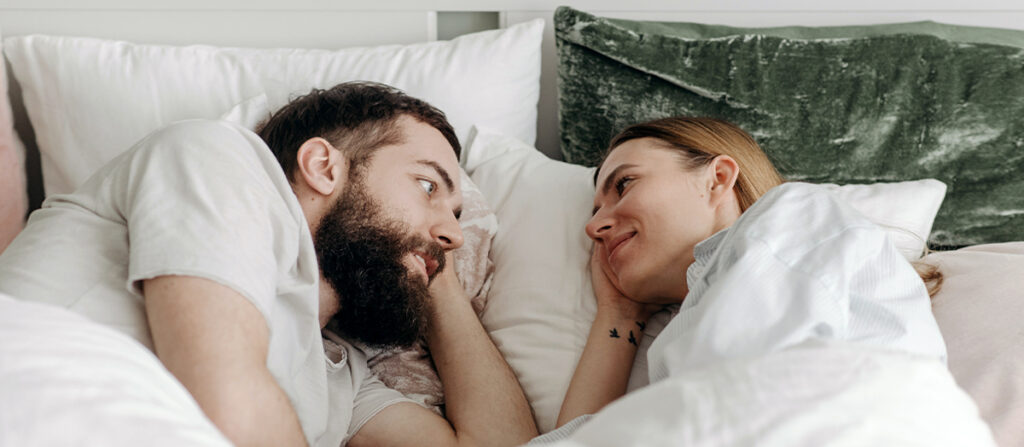 couple in bed talking
