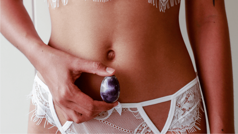 Sexy woman in white with Amethyst Yoni Egg